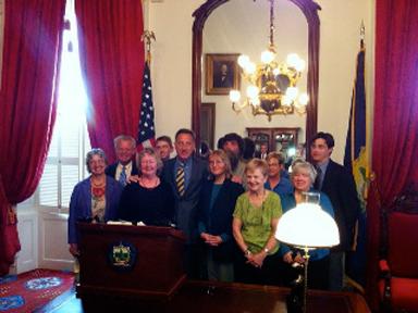 Marijuana Policy Project lobbyists and patient advocates watch SB 17 signed into law. (Image courtesy MPP)