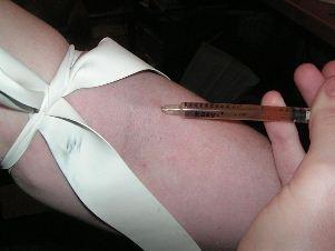 heroin injection, using tourniquet (wikipedia.org)
